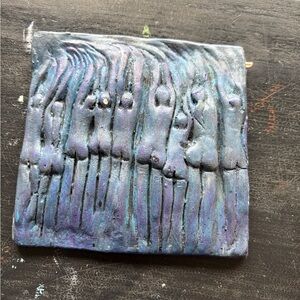 blue ceramic art tile with people figures